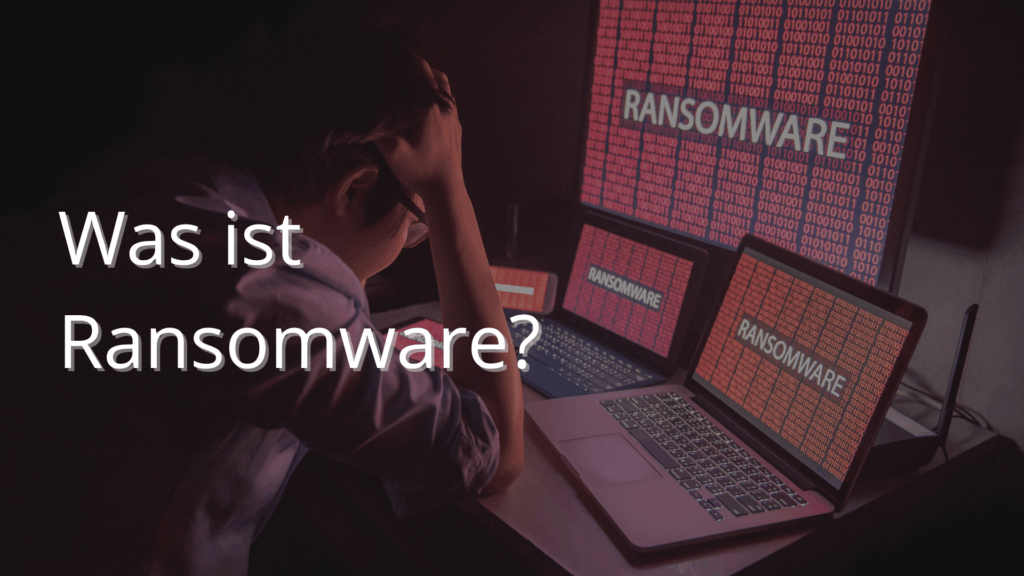 Mann sitzt verzweifelt vor Bildschirmen mit Aufschrift Ransomware
